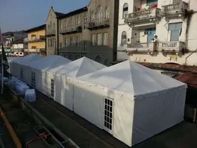 White tents lined up on street