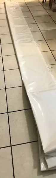 White plastic sheet on tiled floor