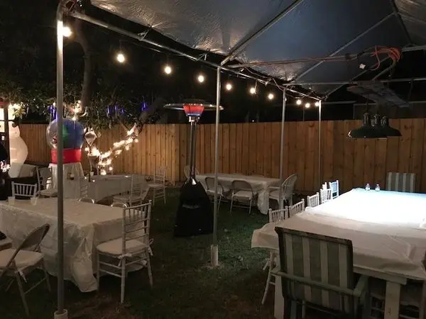 Backyard gathering space with festive lighting