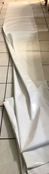 Long white sheet partially unfolded on tiles