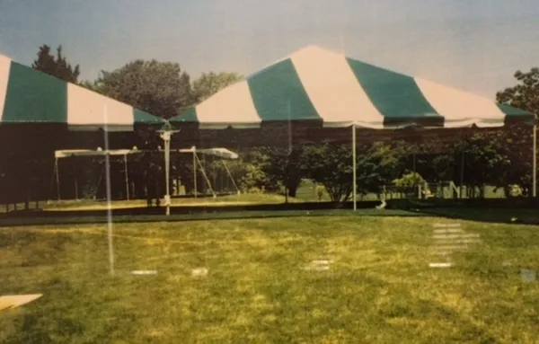 Green and white tents in park