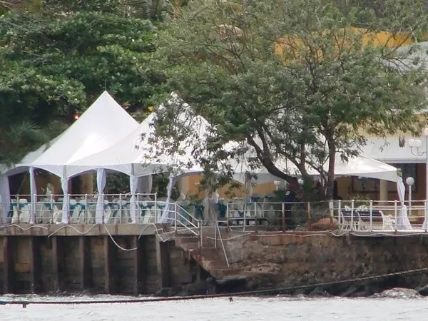 Riverside event venue with white tents