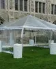 Transparent tent near stone building