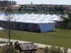 Large white tent on grassy field
