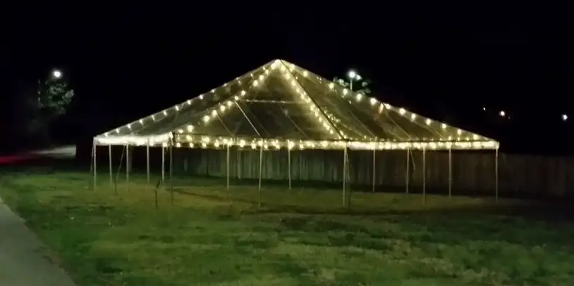 Nighttime view of a lit-up tent
