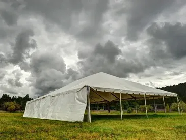 Outdoor tent with stormy clouds overhead