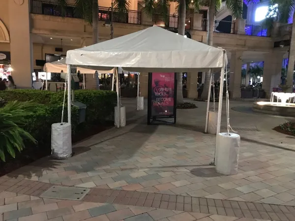 Canopy tent set up in courtyard.