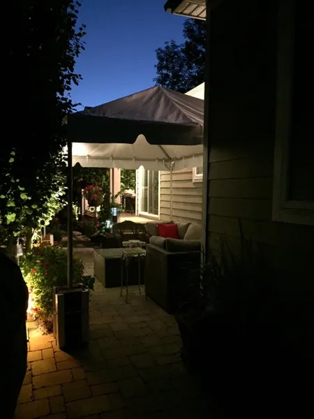 Illuminated backyard patio with evening ambiance