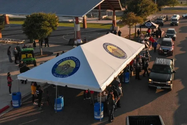 People gathered at outdoor registration booth