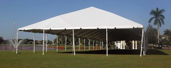 Open-sided white canopy tent over grassy park