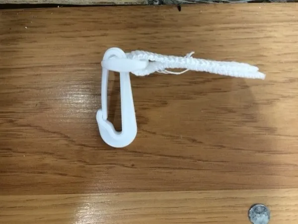White clip attached to fabric loop