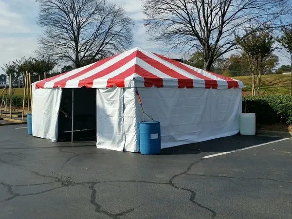 Tent with red stripes in parking lot