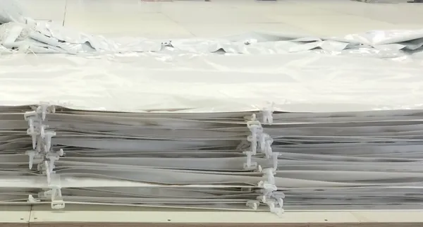 Piled white plastic panels