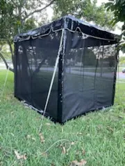 Black outdoor tent on green grass