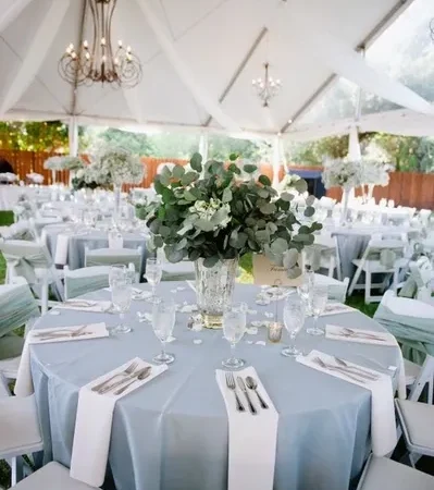 White chairs in decorated tent venue