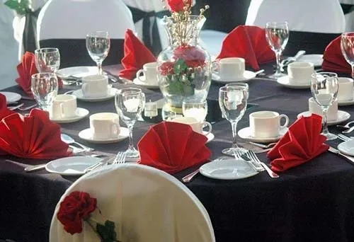 Elegant table setting with red napkins