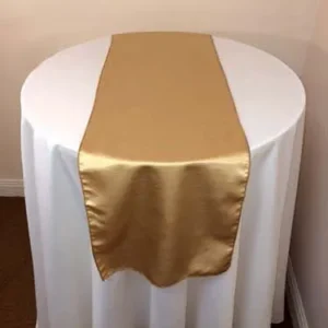 Round table with gold and white linens