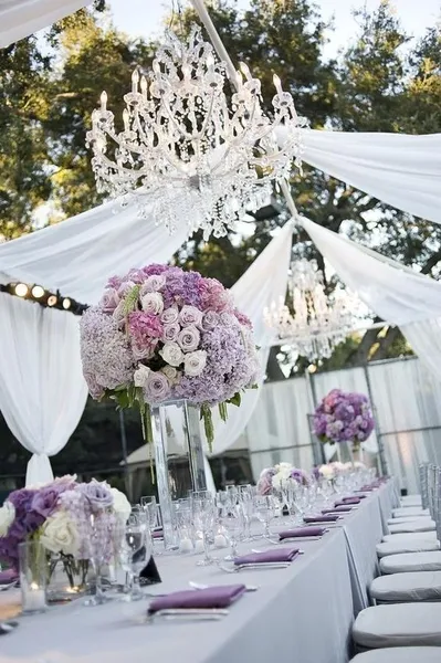 Outdoor reception with purple floral arrangements