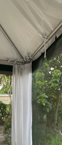 White tent interior with greenery outside