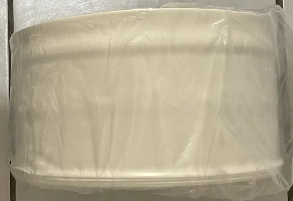 Circular white object covered in plastic