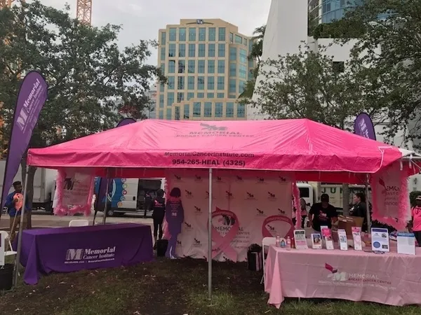 Pink event tent with informational tables