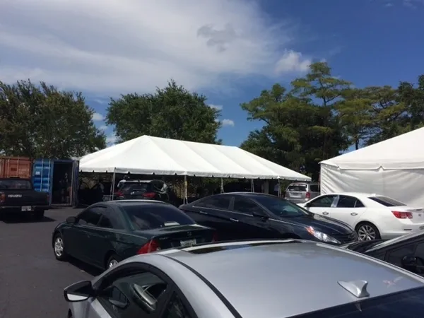 Outdoor parking with white tent shelter