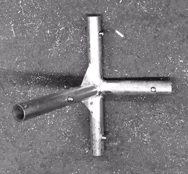 Metal pipe connector on concrete surface