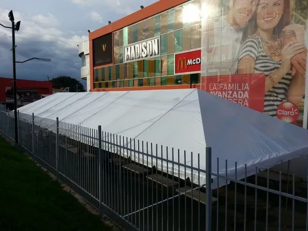 Event setup with white tent and fence