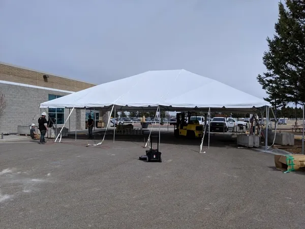 Outdoor event tent with people setting up