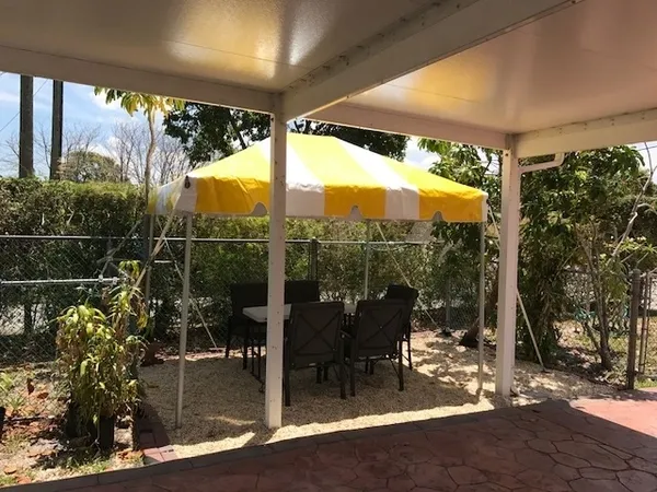 Outdoor seating under yellow and white tent