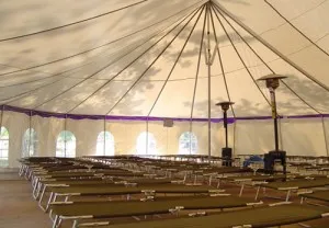 Large tent with rows of cots