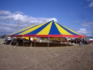 Large striped tent on grassy field
