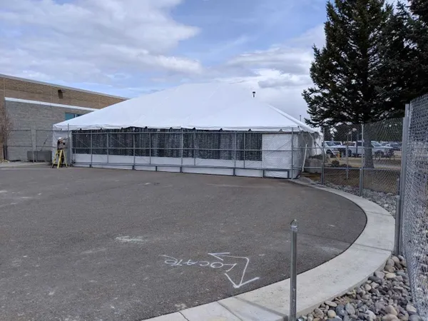 Large white tent beside building