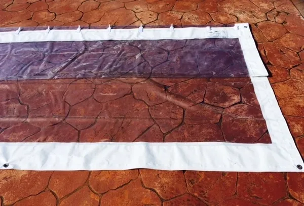 Plastic tarp on stamped concrete surface