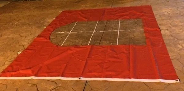 Red fabric with window-like opening.