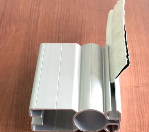 Metal profile on wooden surface