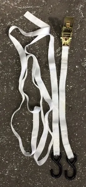 Ratchet tie-down strap on ground