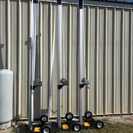 Tall metal supports near corrugated wall