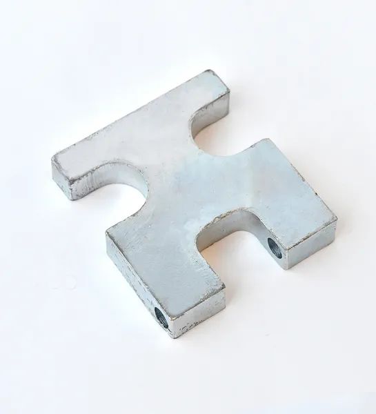 Metallic puzzle piece on white background