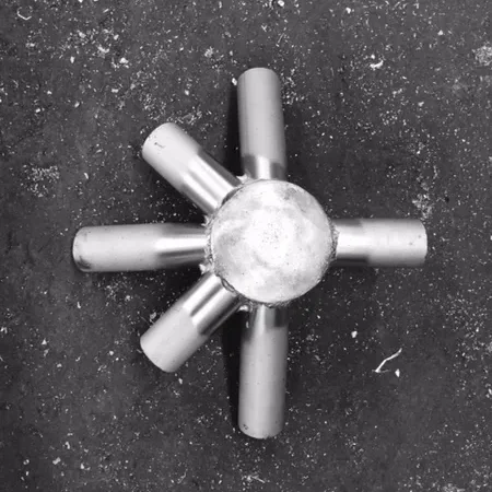Metallic star-shaped object on asphalt