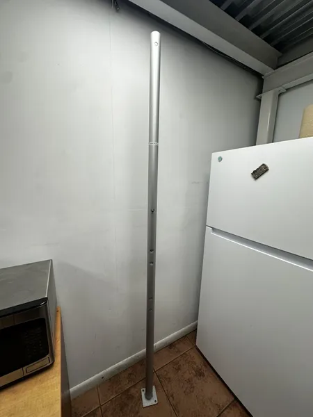 Tall metal pole in corner