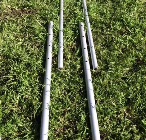 Metal poles lying on grass