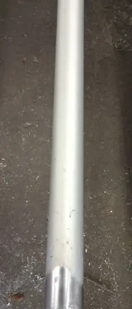 Metallic cylindrical pole on a concrete floor