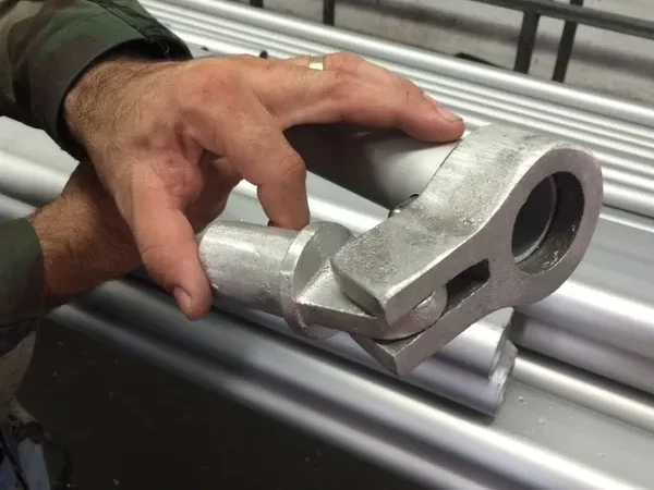 Hand holding a metal joint piece
