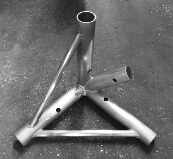 Metal pipe structure on a concrete floor.