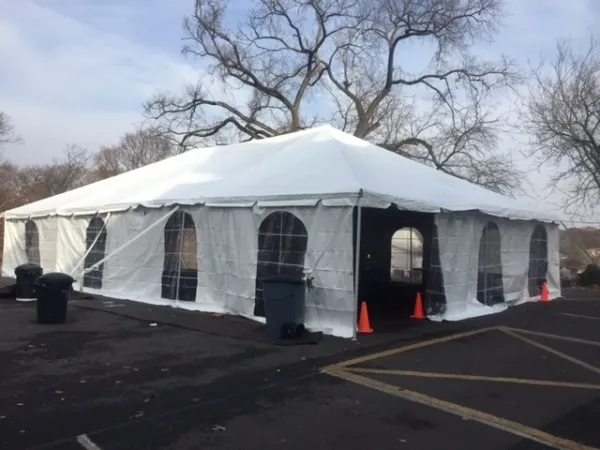 White party tent with arched windows and cones