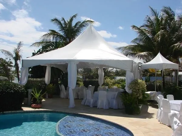 Outdoor wedding setup with poolside tent