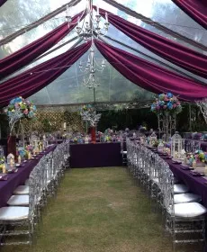 Purple draped tent with banquet tables