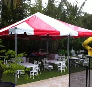 Red and white tent with chairs