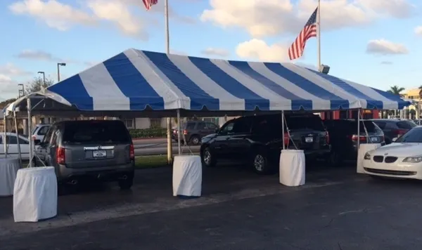Striped tent covering parked cars